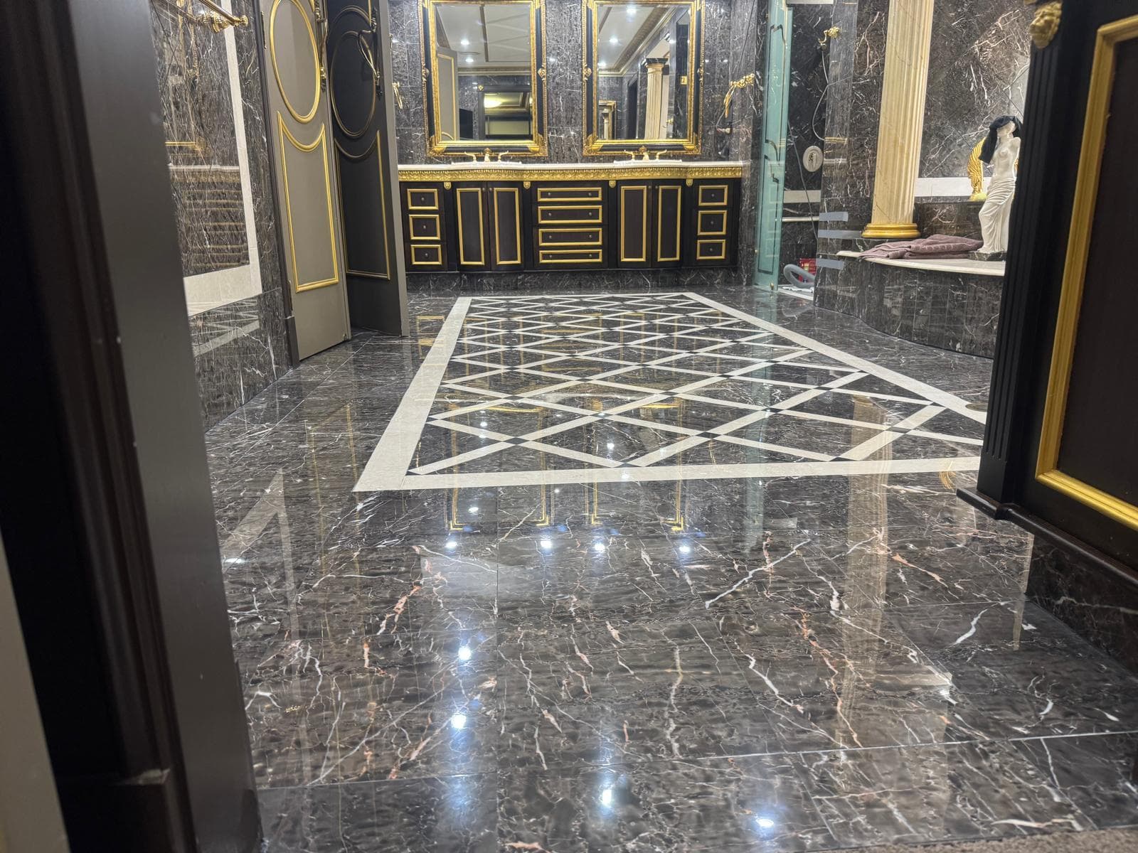 Restored black marble geometric floor inlay in a Brisbane bathroom
