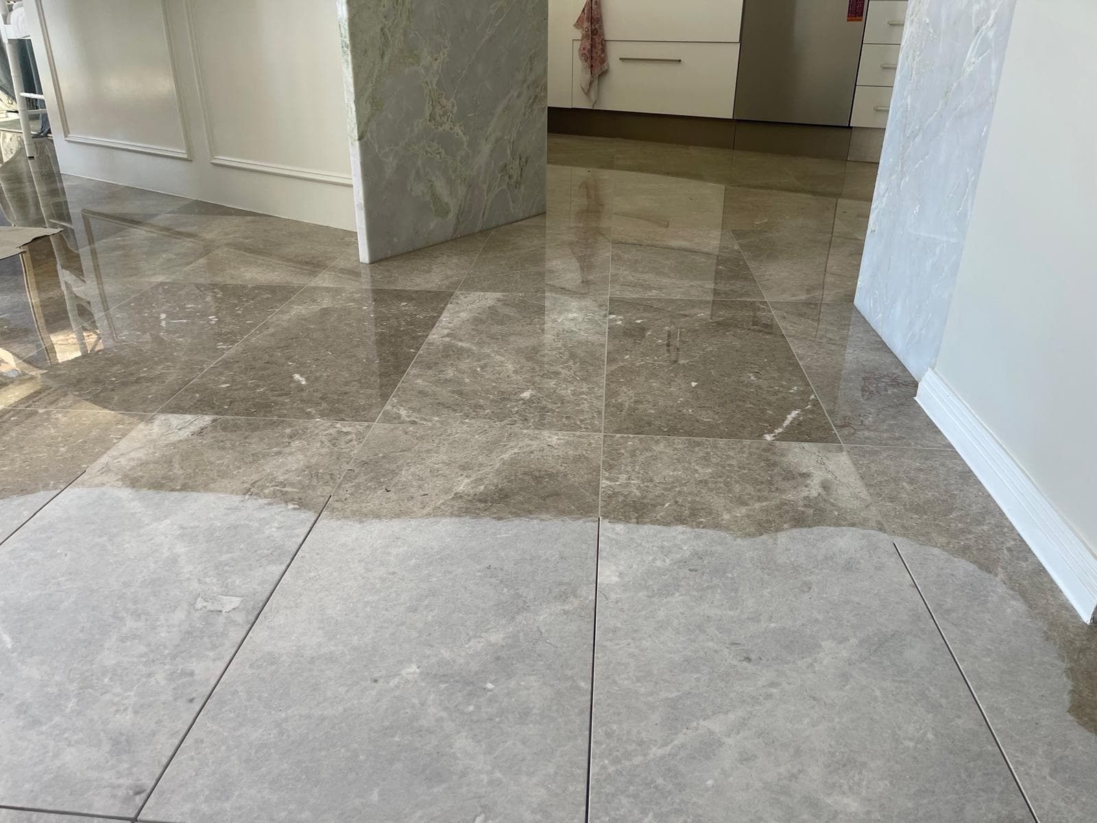 Epoxy resin being worked into stone tile joints during regrouting